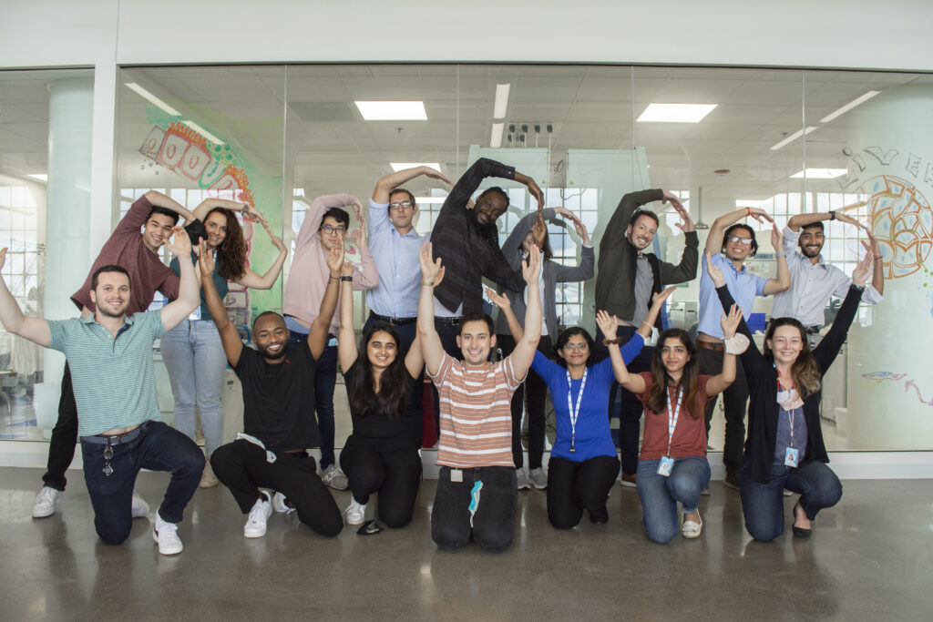 Scientists posing outside of the lab and smiling